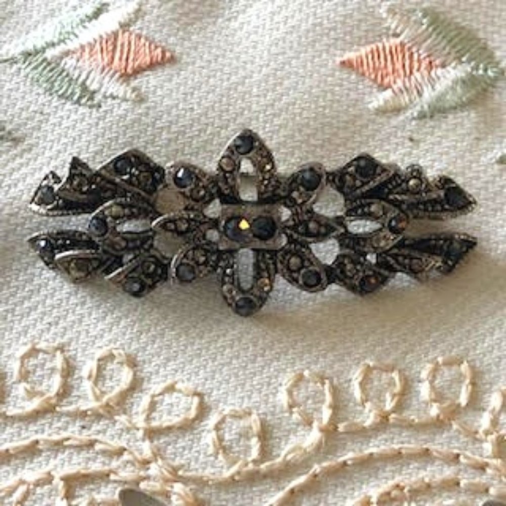 Vintage Brooch shown by its dated clasp with marcasite stone in center